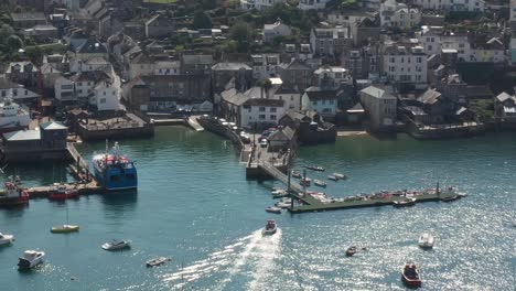 Aerial-view-of-passenger-ferry-docking-at-Polruan-Harbour-from-the-town-of-Fowey,-on-the-river-Fowey,-Cornwall,-UK