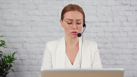 Tracking-shot-of-a-businesswoman-working-in-customer-support-at-a-desk