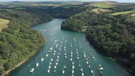 Wide-aerial-view-over-boats-moored-on-the-River-Fowey-in-Cornwall,-UK