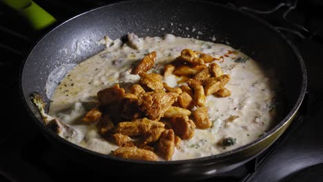 Adding-Fried-Chicken-Breast-Fillet-Into-Creamy-Cheese-Sauce-Boiling-In-A-Pan-And-Stir