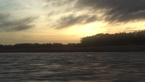 Passing-view-from-a-boat-of-the-tambopata-river-at-sunset