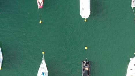 Topdown-aerial-view-of-moored-boats-on-the-River-Fowey,-In-South-Cornwalls-area-of-outstanding-natural-beauty,-Cornwall,-UK