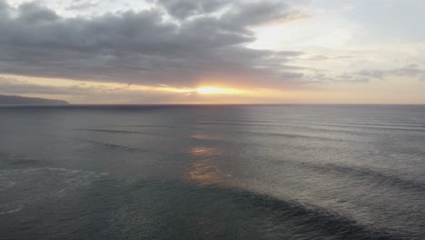 4K-cinematic-drone-shot-of-the-sunset-over-the-ocean-at-Banzai-Pipeline-on-Oahu's-North-Shore