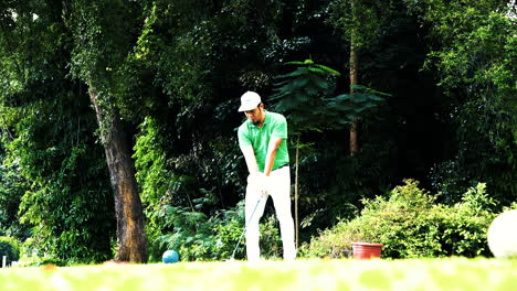 Middle-aged-Malay-Singaporean-man-teeing-off-at-the-green-at-Changi-Village-golf-club,-learning-to-use-the-driver