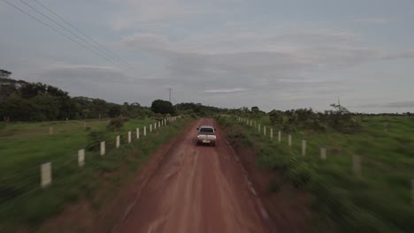Car-Traveling-On-A-Dirt-Road-In-Colombia-On-A-Cloudy-Day---drone-shot