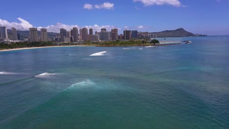 Aerial-view-of-lone-paddle-boarder-cruising-along-Oahu-south-shore