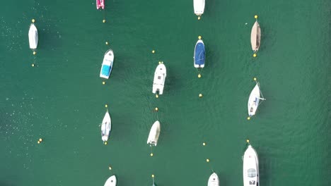 Top-down-aerial-view-of-boats-moored-on-the-River-Fowey,-In-South-Cornwall,-UK