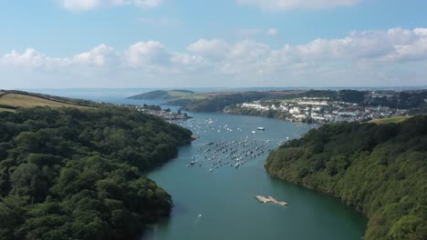 Aerial-view-down-the-River-Fowey,-towards-the-town-of-Fowey-and-Polruan,-Located-in-an-Area-Of-Outstanding-Natural-Beauty-in-Southern-Cornwall