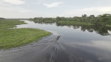 Motorboat-On-The-Tranquil-Waters-Of-Laguna-Negra-In-Colombia---aerial-drone-shot