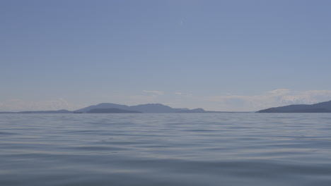 Water-level-view-of-Puget-Sound-and-landscape-from-a-boat-on-the-water-near-Bellingham,-Washington