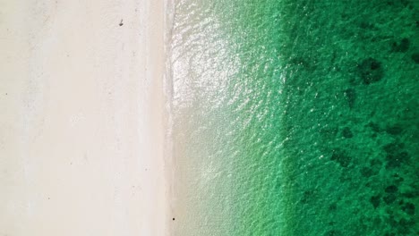 Top-down-aerial-shot-of-a-beach-with-clear-water