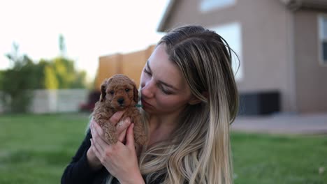 Woman-Pet-Owner-Loving-Newborn-Baby-Golden-Doodle-Puppy-Dog