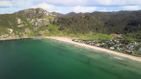 Aerial-view-of-New-Zealand-surf-town-in-secluded-spot