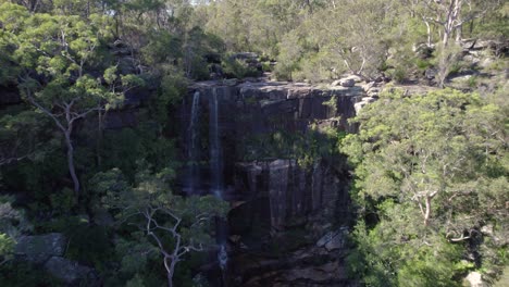Aerial-flyover-of-a-waterfall-and-creek-in-Sydneys-north