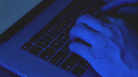 Close-up-hands-of-hacker-typing-code-on-laptop-keyboard