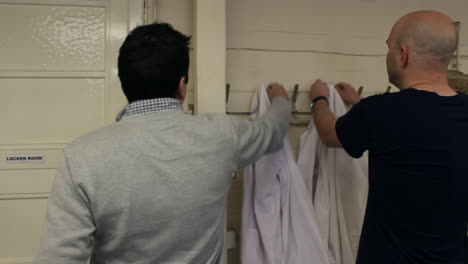 Scientists-hanging-up-lab-coats-after-finishing-work-in-a-laboratory