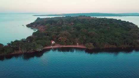 Drone-approaching-the-shore-of-Banda-Island-beach,-Uganda,-in-the-island-Ssese-archipelago,-Lake-Victoria