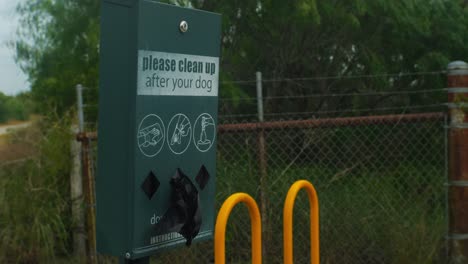 Please-Clean-Up-After-Your-Dog-sign-with-pet-poop-bags