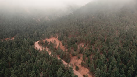 Portion-of-Cheyenne-Valley-Trail-in-Colorado,-covered-in-mist,-aerial-view