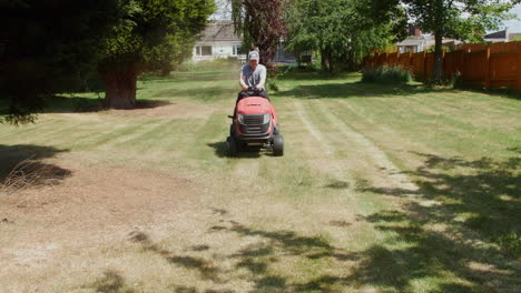 Cutting-grass-with-a-lawn-mower-in-a-garden