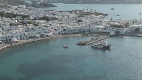 Mykonos-Town-4K-drone-clip-highlighting-old-port,-Matoyianni-area-and-the-famous-windmills-in-the-background