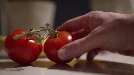 Close-up-of-two-tomatoes-on-vine-on-a-kitchen-counter