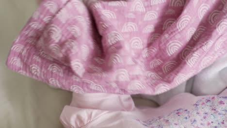 Palmar-Grasp-Reflex-of-Young-Baby-in-Bed-Grabbing-Blanket