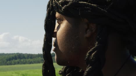 Samson-looking-around-and-turning-to-face-surrounding-green-landscape,-Biblical-character-with-long-dreads,-Israelite-warrior-and-judge,-black-male-in-old-testament,-Christian