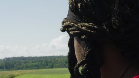 Samson-with-arms-raised-while-looking-at-surrounding-green-landscape,-Biblical-character-with-long-dreads,-Israelite-warrior-and-judge,-black-male-in-old-testament,-Christian