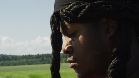 Samson-looking-down-and-around-at-surrounding-green-landscape,-Biblical-character-with-long-dreads,-Israelite-warrior-and-judge,-black-male-in-old-testament,-Christian