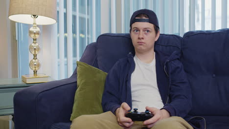 Young-man-looks-concerned-while-playing-video-games