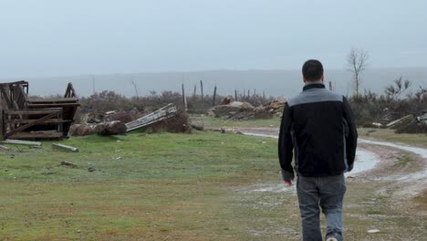 Man-walks-alone-in-a-place-that-is-devastated-after-a-natural-disaster