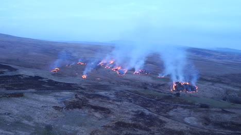 Beautiful-cinematic-aerial-shot-flying-over-burning-land