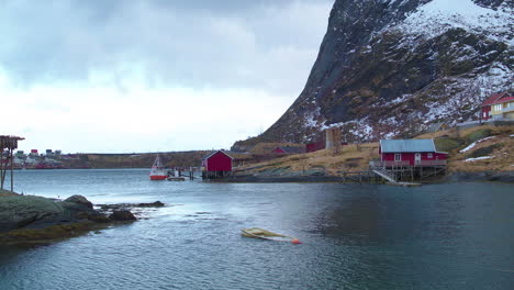 Cinematic-tracking-reveal-shot-of-fish-racks-in-Reine,-Lofoten,-Norway