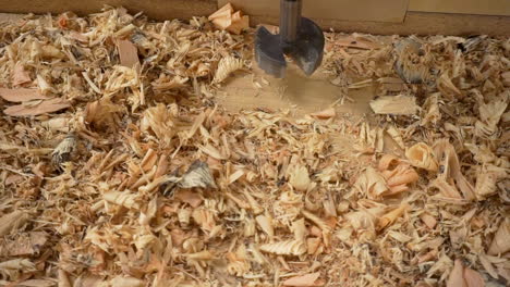 Slow-panning-clip-of-wood-shavings-on-a-drill-press