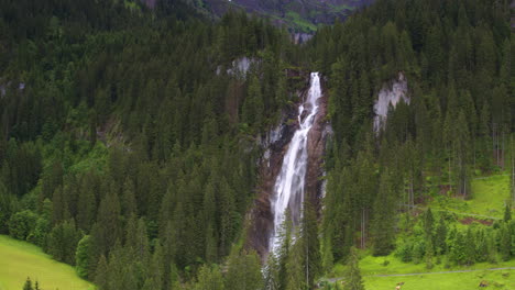 Cinematic-aerial-shot-reversing-and-revealing-Iffiigfall-waterfall,-Switzerland