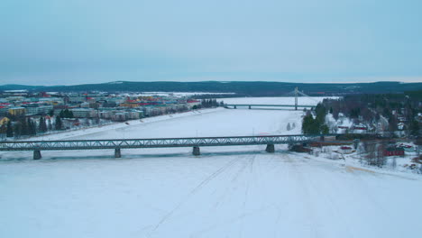 Cinematic-aerial-shot-towards-the-two-bridges-in-Rovaniemi,-Finland