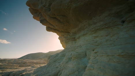 Stunning-cinematic-tracking-shot-of-sandstone-formations-with-more-sky
