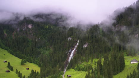 Stunning-cinematic-aerial-shot-through-the-clouds-towards-Iffiigfall-waterfall