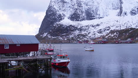 Cinematic-tracking-shot-of-a-boathouse-and-fishing-boats-in-Reine,-Lofoten