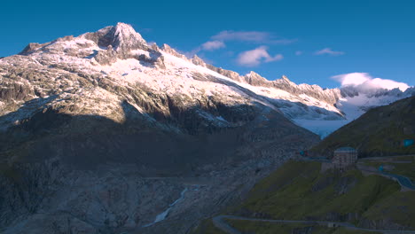 Cinematic-wide-aerial-shot-approaching-the-Rhone-Glacier,-Switzerland