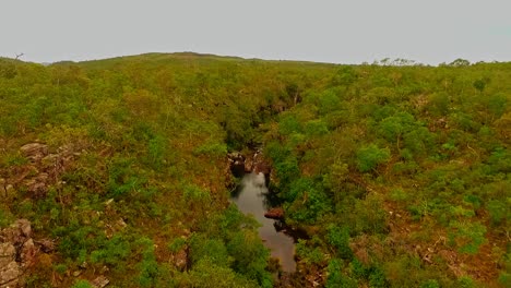 Aerial-drone-shot-flying-over-a-rocky-river-in-the-South-American-countryside