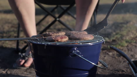 Burgers-cooking-on-portable-outdoors-bbq