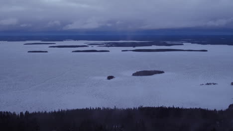 Cinematic-aerial-shot-revealing-the-top-of-Koli-mountain-from-Lake-Pielinen