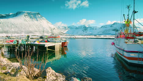 Stunning-cinematic-tilt-up-shot-of-fishing-boats-in-Tromvik,-Norway