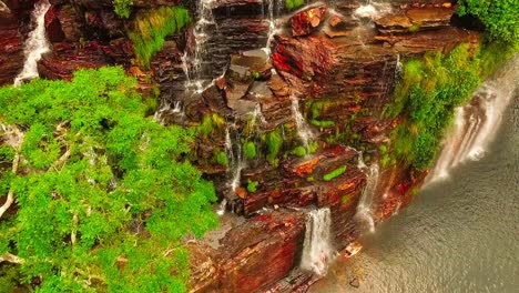 Beautiful-canyon-cliff-wall-with-streams-of-water-flowing-down-as-the-camera-tilts-downwards