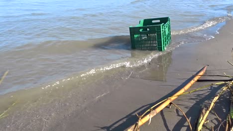 a-Washed-up-plastic-crate-on-a-beach