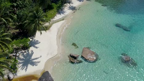 Aerial,-drone-shot-over-a-paradise-beach,-at-the-turquoise-sea,-on-a-sunny-day,-in-Koh-Kood,-Thailand,-Asia