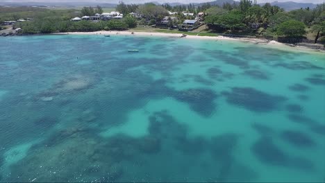 Blue-coral-reef-waters-next-to-the-shoreline-at-the-island-of-Mauritius-on-bright-sunny-vacation-day