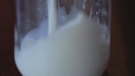 Closeup-shot,-milk-getting-poured-in-glass